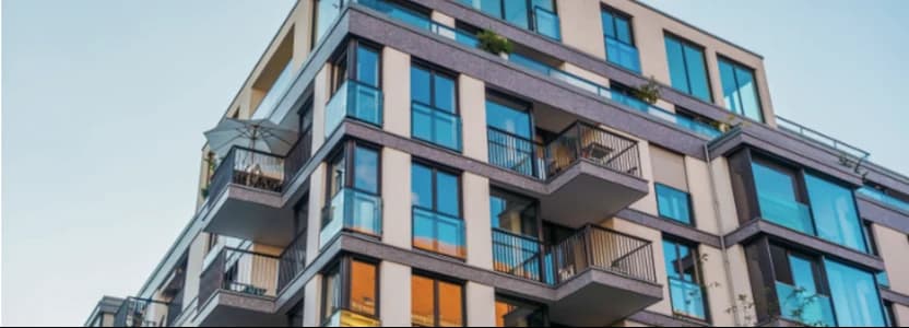 modern corner 5 floor condominium complex with blue-coloured windows