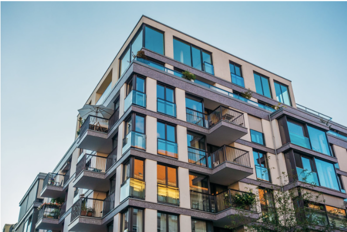 modern corner 5 floor condominium complex with blue-coloured windows